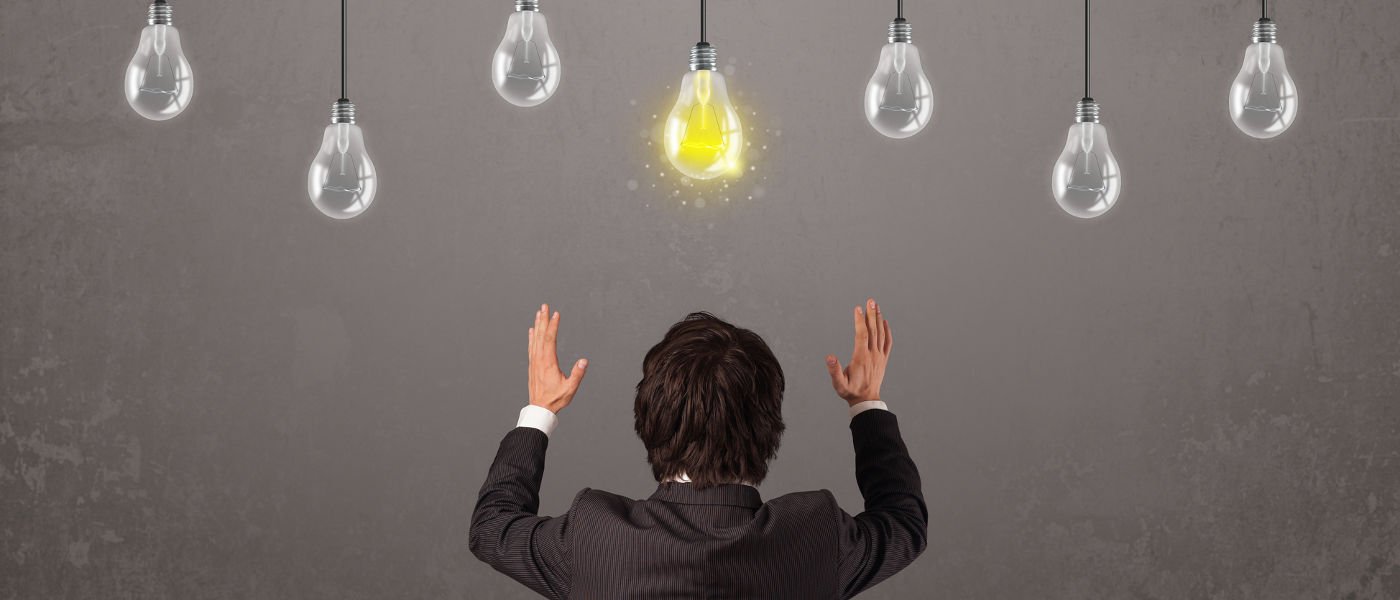 Businness guy in front of bright idea light bulbs concept